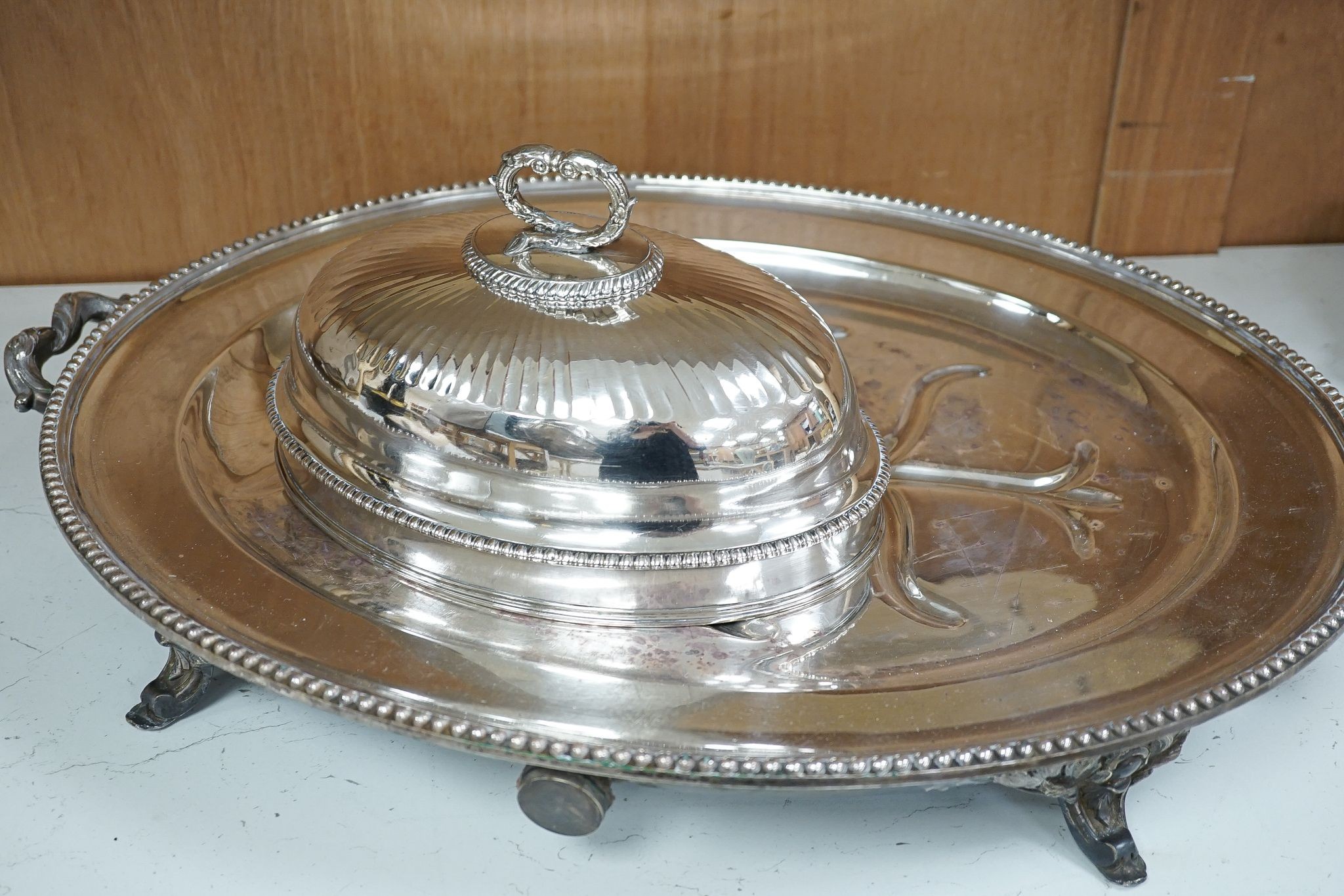 Two Victorian electroplate meat domes, and a hot water meat dish, 62 cms wide including handles.